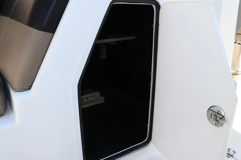 Slide: The Image of Open storage compartment on a 2016 Hurricane SunDeck 2486 OB boat. - 21