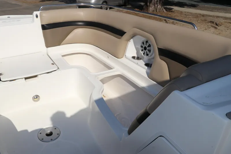 Slide: The Image of 2016 Hurricane SunDeck 2486 OB boat interior with beige seating and built-in speaker. - 26