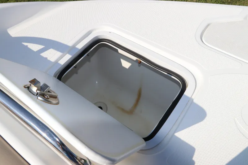 Slide: The Image of Open storage compartment on 2016 Hurricane SunDeck 2486 OB boat deck. - 31