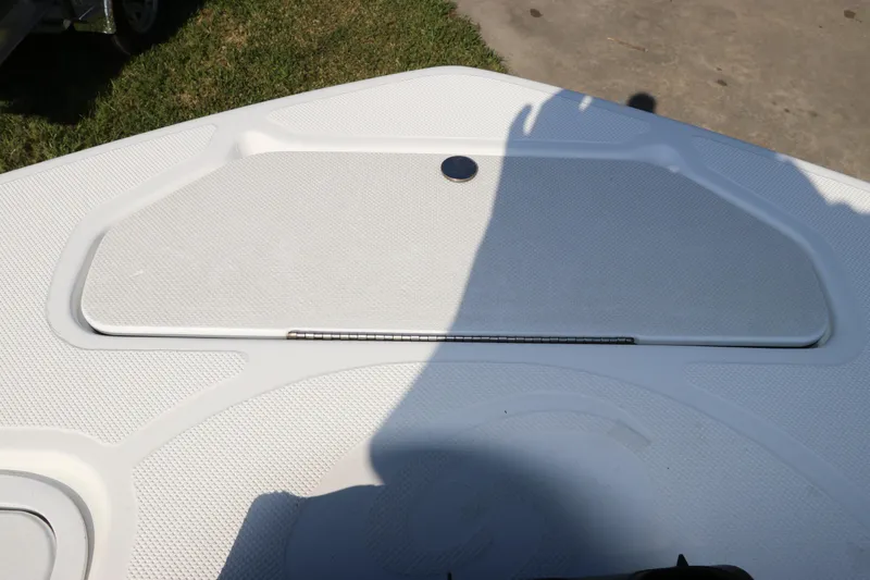 Slide: The Image of 2016 Hurricane SunDeck 2486 OB boat deck with storage compartment and textured surface. - 32