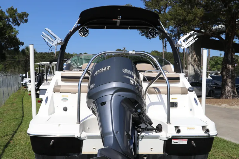 Slide: The Image of 2016 Hurricane SunDeck 2486 OB boat with Yamaha 250 engine, parked outdoors. - 6
