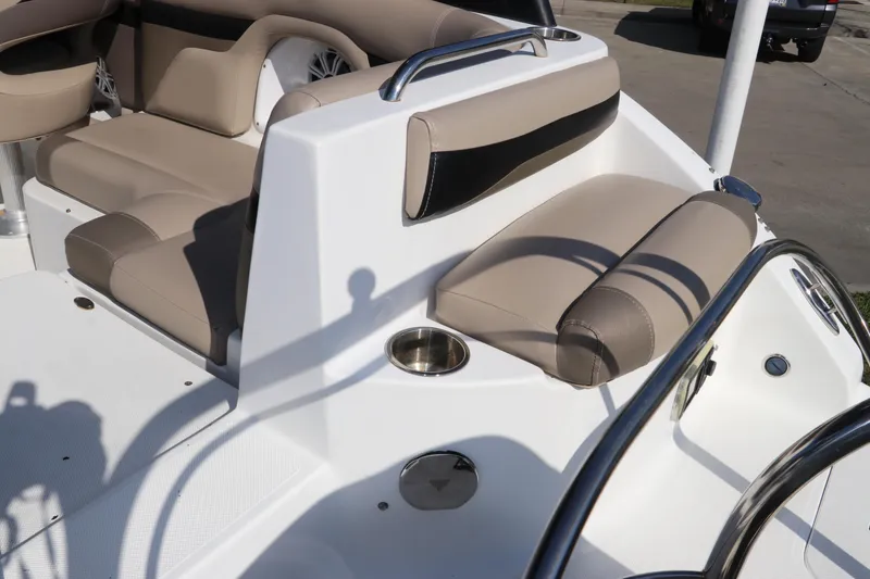 Slide: The Image of 2016 Hurricane SunDeck 2486 OB boat interior with beige seating and cup holder. - 7