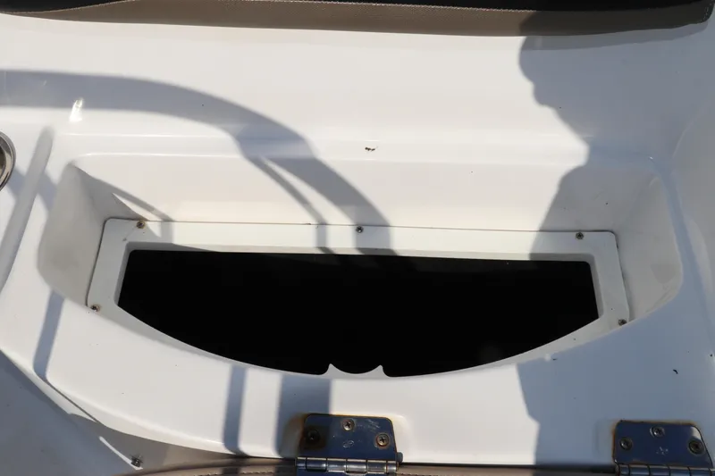 Slide: The Image of 2016 Hurricane SunDeck 2486 OB storage compartment with open hatch, showcasing interior space. - 8