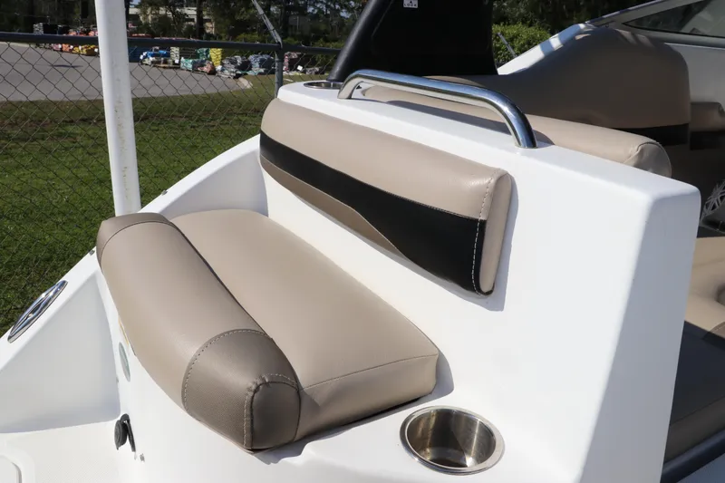 Slide: The Image of 2016 Hurricane SunDeck 2486 OB boat seating with beige upholstery and stainless steel cup holder. - 9