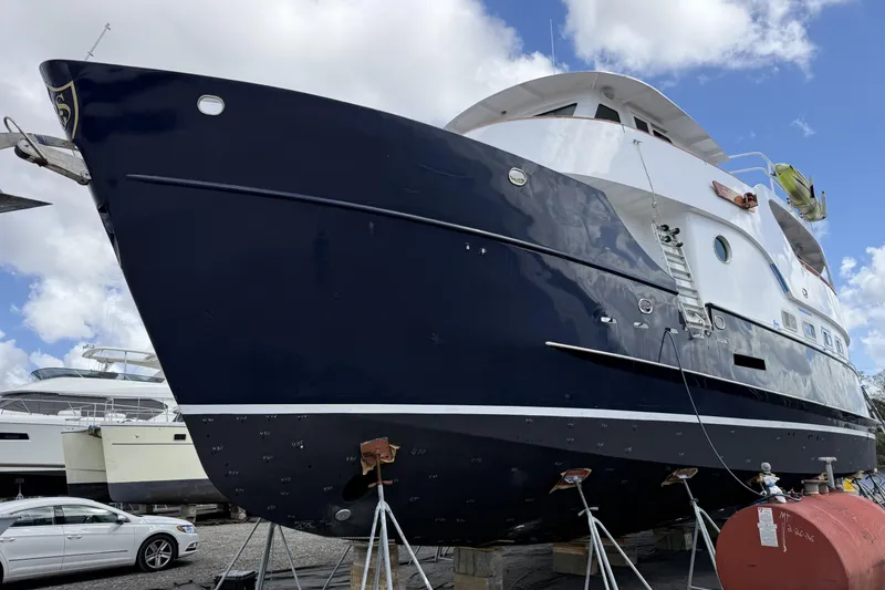The Image of 1997 Real Ships 61' Islander yacht on dry dock, blue hull, white superstructure. - 0