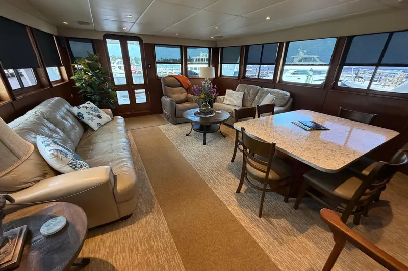Slide: The Image of Luxurious interior of 1997 Real Ships 61' Islander yacht with leather seating and wooden table. - 10