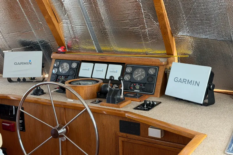 Slide: The Image of Interior of 1997 Real Ships 61' Islander yacht with wooden stairs and seating area. - 11