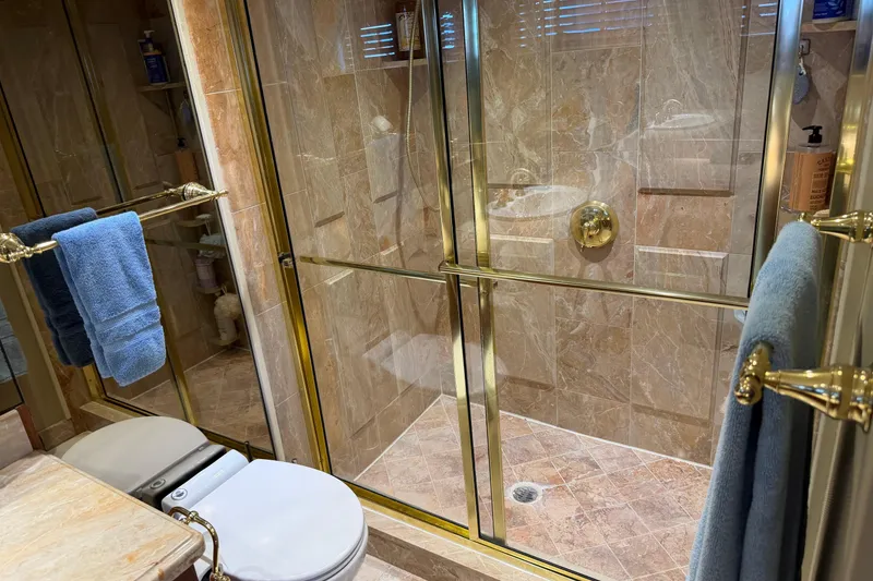 Slide: The Image of Interior of 1997 Real Ships 61' Islander with wooden cabinets and decorative items. - 18