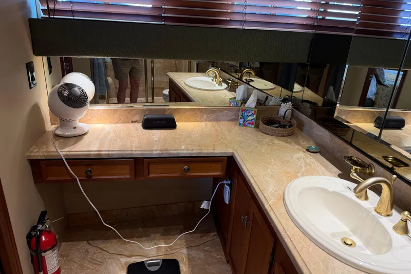 Slide: The Image of Cozy cabin interior of 1997 Real Ships 61' Islander with nautical-themed bedding. - 19