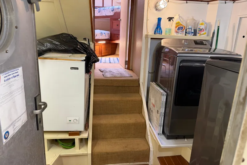 Slide: The Image of Laundry area on a 1997 Real Ships 61' Islander yacht with washer and dryer. - 27