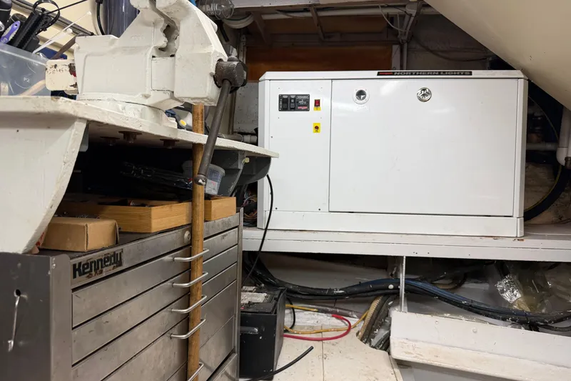 Slide: The Image of Laundry area on 1997 Real Ships 61' Islander with appliances and cleaning supplies. - 29