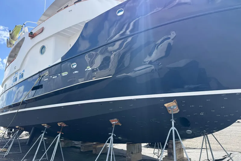Slide: The Image of A 1997 Real Ships 61' Islander yacht docked in a marina under clear blue skies. - 3