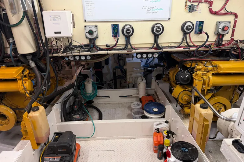 Slide: The Image of Storage room on a 1997 Real Ships 61' Islander with organized shelves and cleaning equipment. - 32