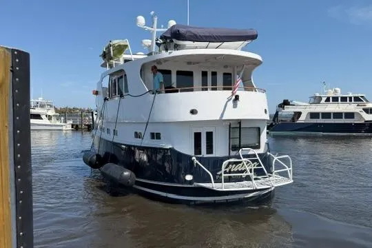 Slide: The Image of Luxurious interior of 1997 Real Ships 61' Islander yacht with cozy seating and dining area. - 5