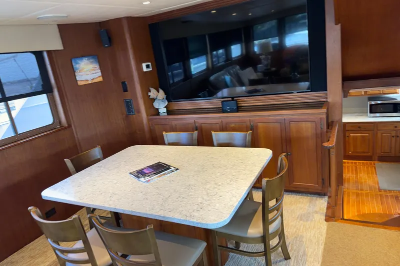 Slide: The Image of Kitchen area of 1997 Real Ships 61' Islander with wooden cabinets and marble countertops. - 8