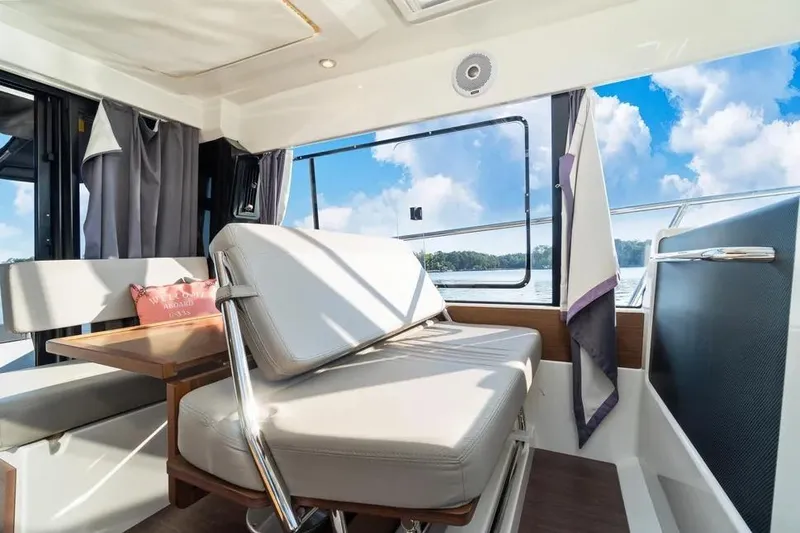 Slide: The Image of Interior of 2021 Jeanneau NC 1095 boat with seating and table, overlooking water. - 22