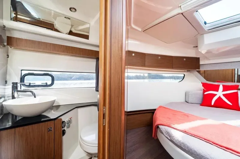 Slide: The Image of Luxurious interior of 2021 Jeanneau NC 1095 yacht featuring cozy bedroom and modern bathroom. - 26