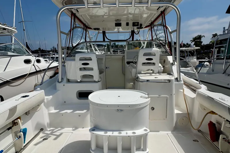 Slide: The Image of 2005 Boston Whaler 305 Conquest boat interior with seating and helm station. - 10