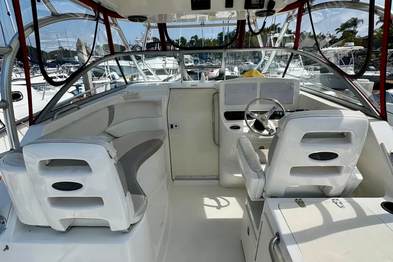 Slide: The Image of 2005 Boston Whaler 305 Conquest boat interior with helm, seating, and dashboard controls. - 11
