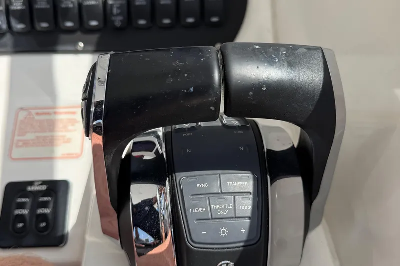 Slide: The Image of Throttle controls on a 2005 Boston Whaler 305 Conquest boat dashboard. - 15