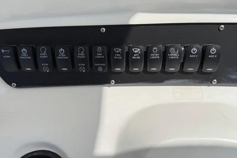 Slide: The Image of Control panel of a 2005 Boston Whaler 305 Conquest boat with labeled switches. - 16