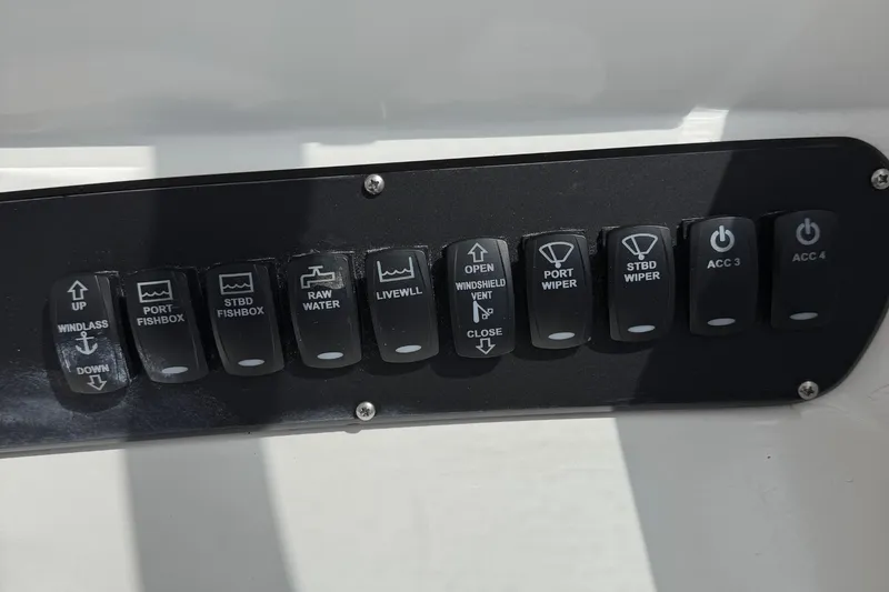 Slide: The Image of Control panel of a 2005 Boston Whaler 305 Conquest boat with labeled switches. - 17