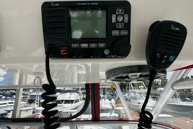 Slide: The Image of 2005 Boston Whaler 305 Conquest VHF marine radio and microphone on boat dashboard. - 18