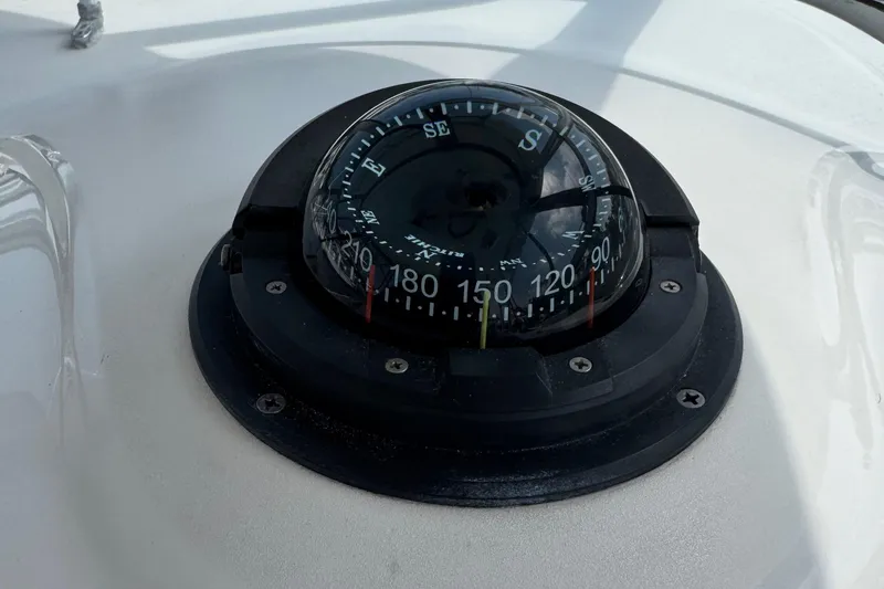 Slide: The Image of Compass on 2005 Boston Whaler 305 Conquest boat dashboard. - 19