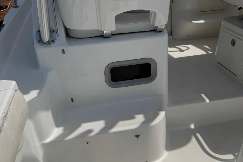 Slide: The Image of 2005 Boston Whaler 305 Conquest boat interior, featuring seating and storage compartments. - 22