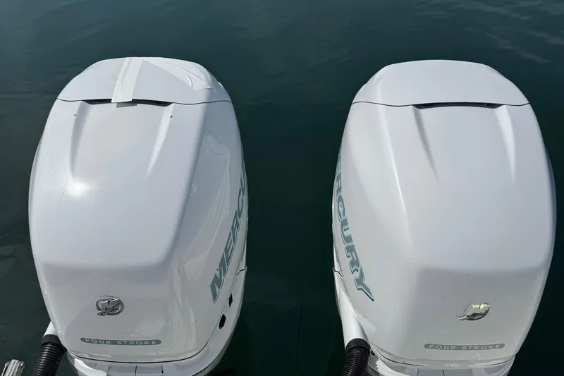 Slide: The Image of Twin Mercury outboard engines on a 2005 Boston Whaler 305 Conquest boat. - 29