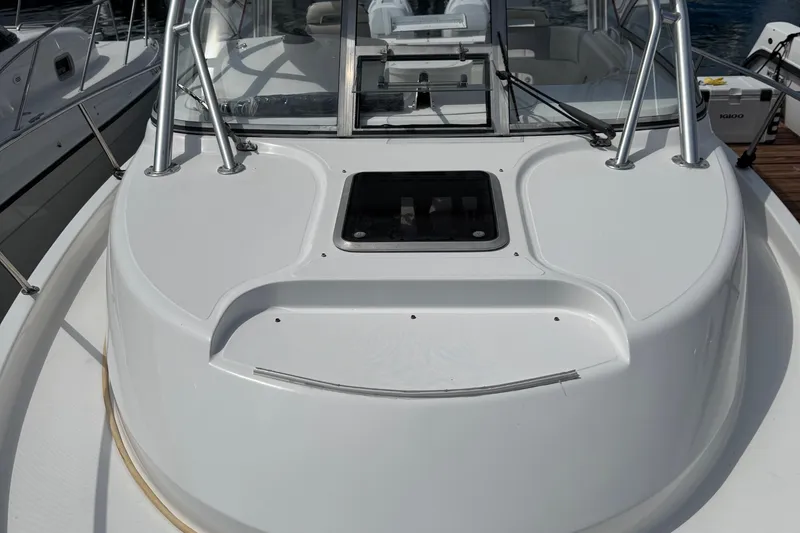 Slide: The Image of 2005 Boston Whaler 305 Conquest boat deck with windshield and railing. - 32