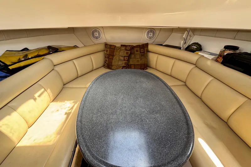 Slide: The Image of Interior of 2005 Boston Whaler 305 Conquest with beige seating and oval table. - 37