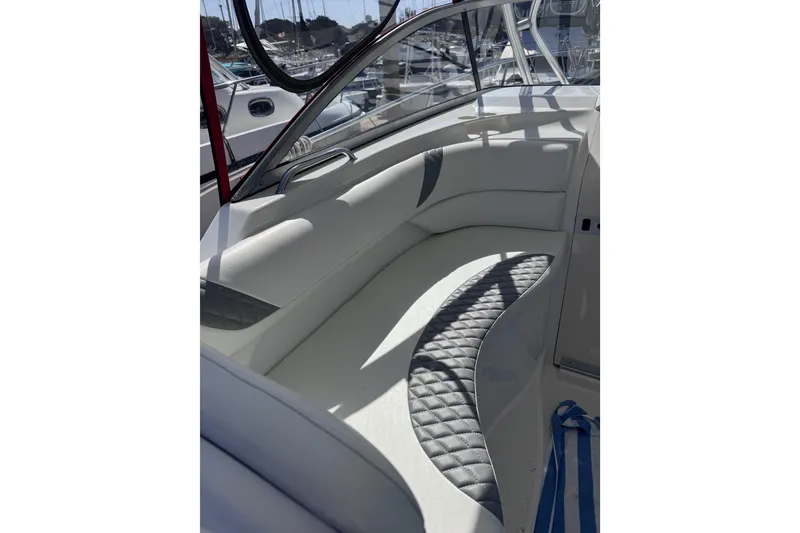 Slide: The Image of 2005 Boston Whaler 305 Conquest interior seating with quilted upholstery and window view. - 42