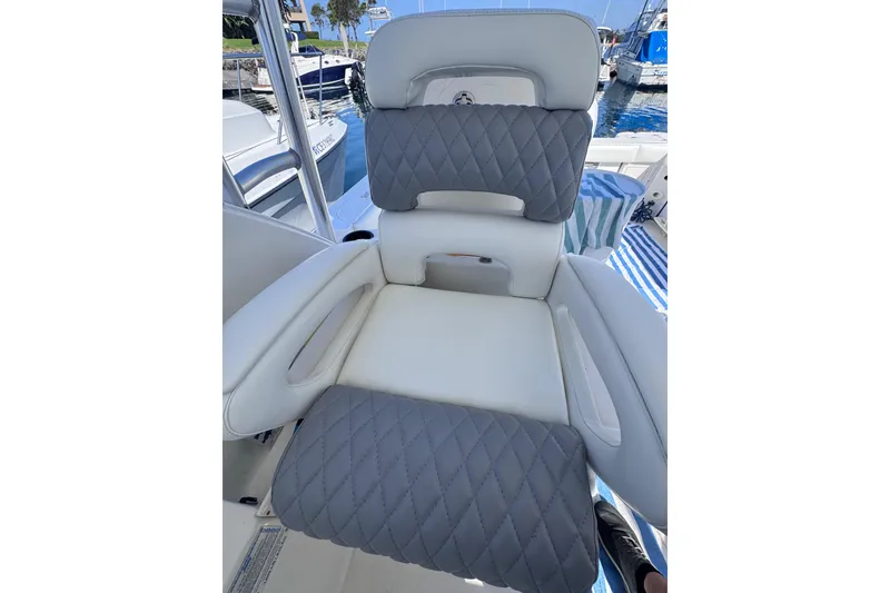 Slide: The Image of Captain's seat on a 2005 Boston Whaler 305 Conquest boat, featuring quilted upholstery. - 44