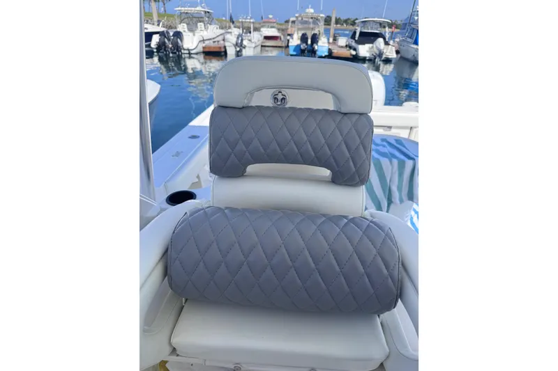 Slide: The Image of 2005 Boston Whaler 305 Conquest boat seat with quilted gray cushions at marina. - 48