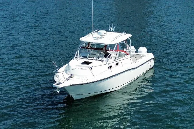 Slide: The Image of 2005 Boston Whaler 305 Conquest boat on calm blue water. - 6