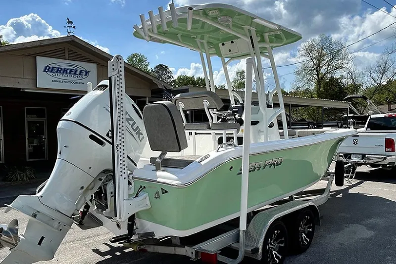 Slide: The Image of 2023 Sea Pro 199 Deep V Center Console boat with Suzuki engine at dealership. - 2