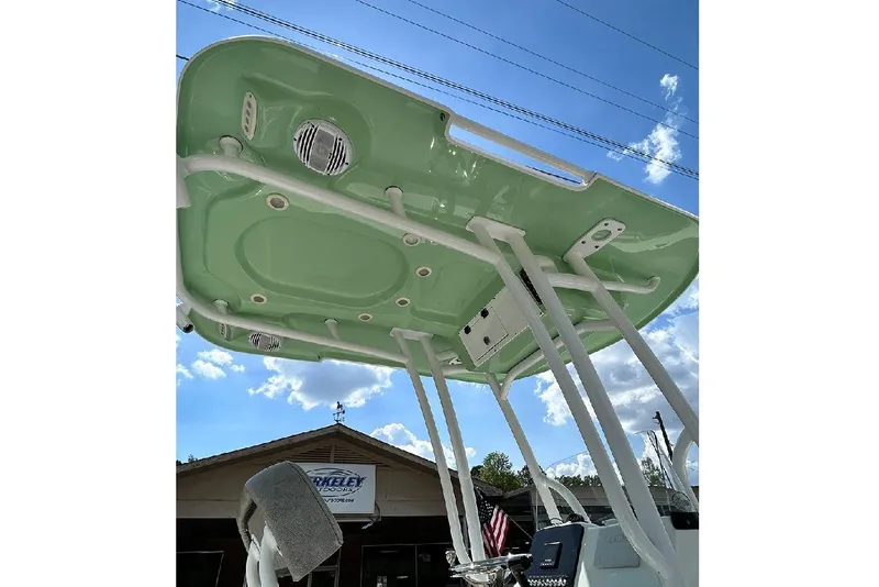 Slide: The Image of 2023 Sea Pro 199 Deep V Center Console boat with green T-top under blue sky. - 6