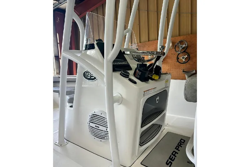 Slide: The Image of 2023 Sea Pro 199 Deep V Center Console boat interior with steering wheel and controls. - 7