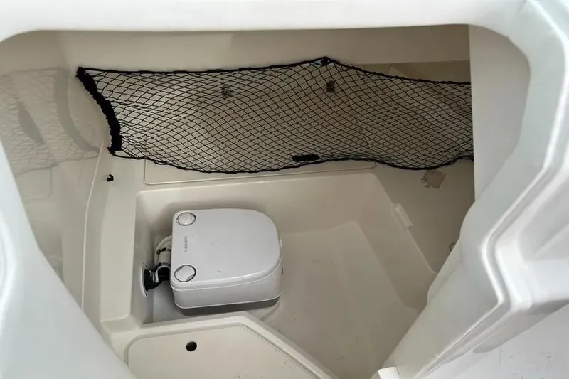 Slide: The Image of Interior of 2019 Sea Ray SDX 250 Outboard boat with portable toilet and storage net. - 5