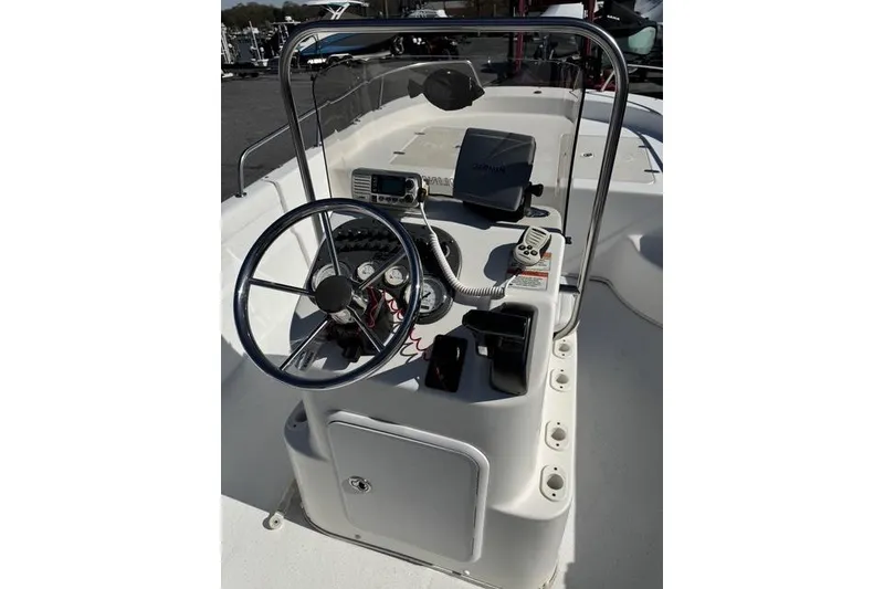 Slide: The Image of 2011 Carolina Skiff 218 DLV boat console with steering wheel and navigation equipment. - 7