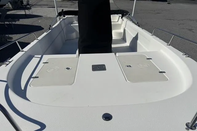 Slide: The Image of 2011 Carolina Skiff 218 DLV boat interior with storage compartments and seating. - 14