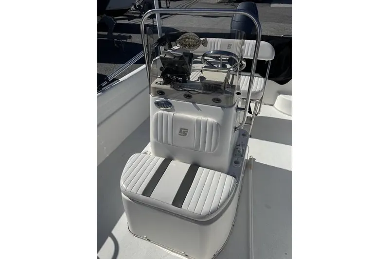 Slide: The Image of 2011 Carolina Skiff 218 DLV boat console with steering wheel and seating. - 3