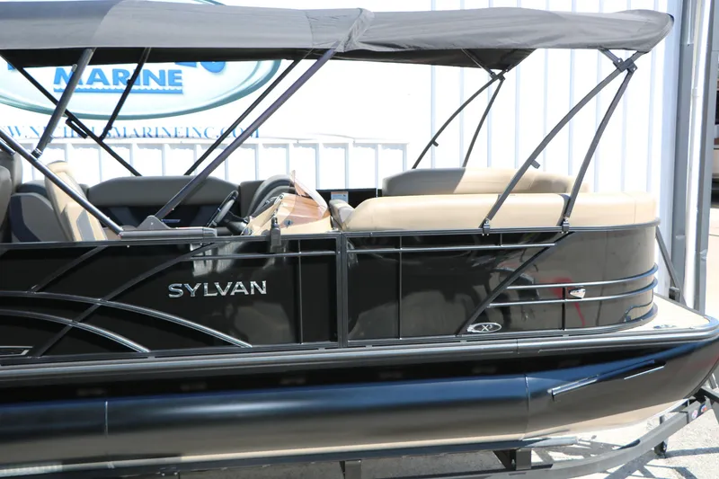 Slide: The Image of 2026 Sylvan Mirage X3 Party Fish pontoon boat with sleek black design and canopy. - 11