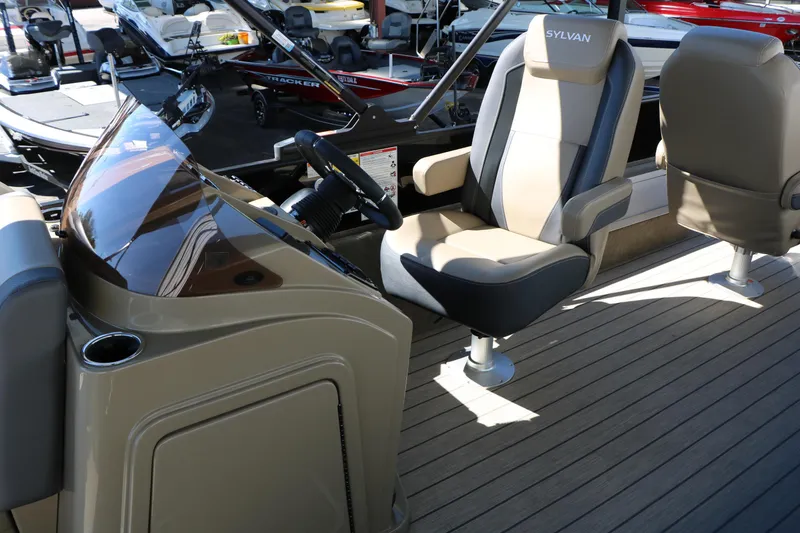 Slide: The Image of 2026 Sylvan Mirage X3 Party Fish boat interior with modern seating and steering console. - 20