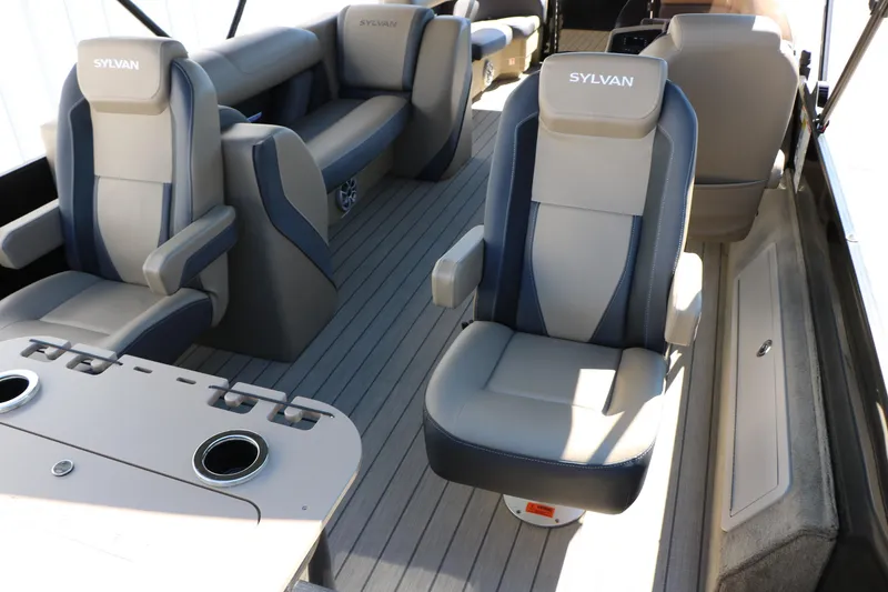 Slide: The Image of 2026 Sylvan Mirage X3 Party Fish boat interior with plush seating and cup holders. - 25