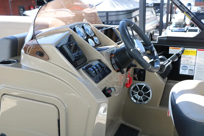 Slide: The Image of 2026 Sylvan Mirage X3 Party Fish boat dashboard with steering wheel and control panel. - 34