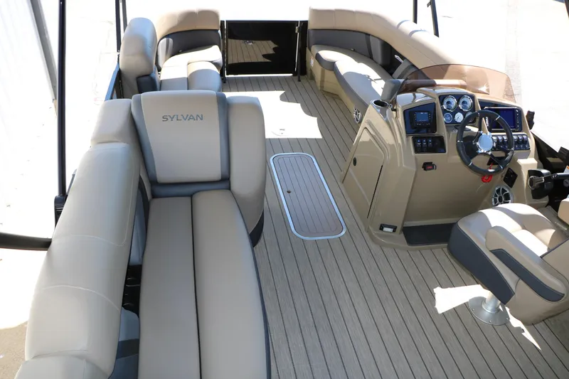 Slide: The Image of 2026 Sylvan Mirage X3 Party Fish pontoon boat interior with plush seating and modern dashboard. - 39