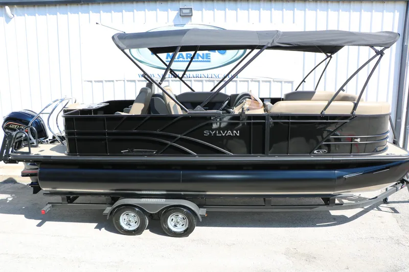 Slide: The Image of 2026 Sylvan Mirage X3 Party Fish pontoon boat with canopy on trailer. - 9
