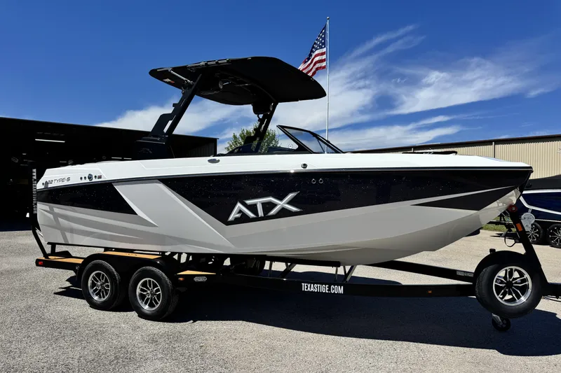 The Image of 2026 ATX Surf Boats 22 Type-S on trailer, sleek design, American flag in background. - 0